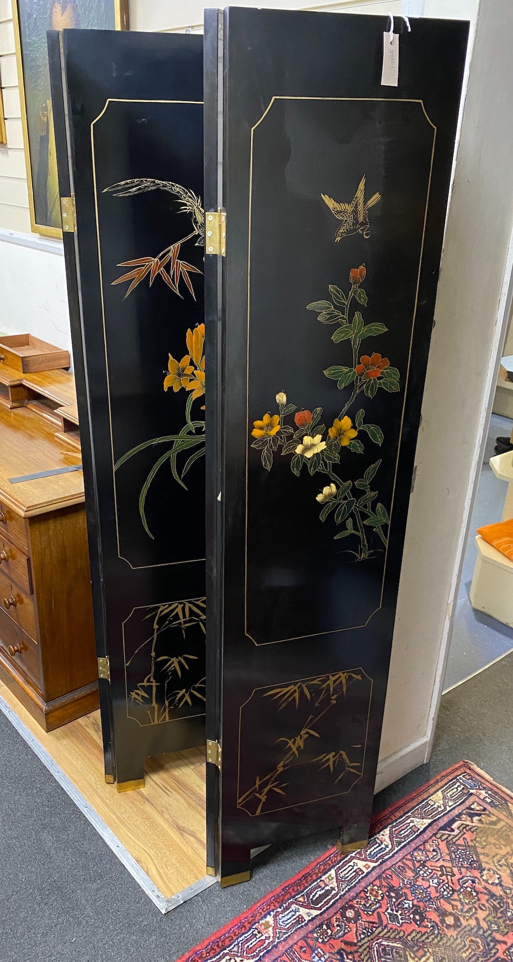 A Chinese lacquer four fold dressing screen, each panel width 40cm, height 184cm
